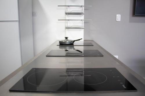 a kitchen with a stove with a pot on it at Sin Fin Hostel in Mendoza