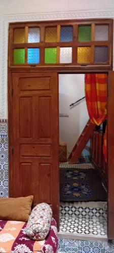 a room with a wooden door and a bunk bed at Moroccan Dream Hostel in Fès
