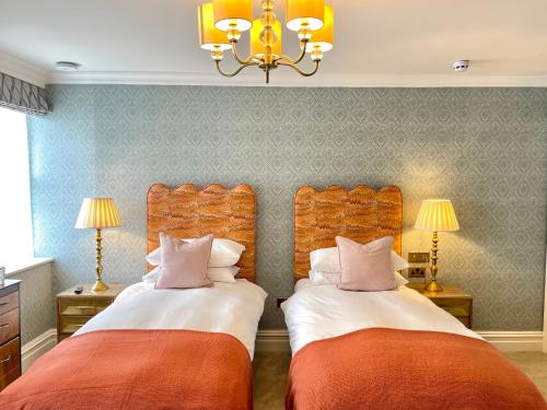 two beds sitting next to each other in a room at Old Town House by Ezestays in Margate