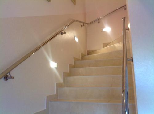 a set of stairs in a house with lights at Apartments Brnada in Umag