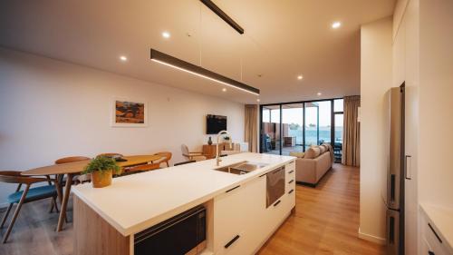 an open kitchen and dining room with a table and chairs at Beautiful urban apartment 2 in Nelson