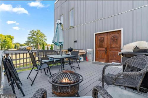a patio with a table and chairs and a grill at Stafford Virginia Stay in Stafford