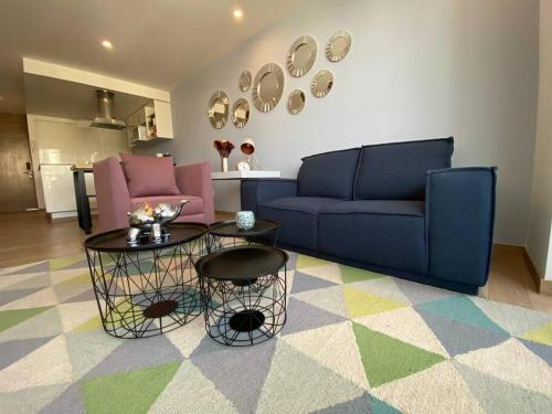 a living room with a blue couch and a table at Cómodo departamento en Polanco. Pool, gym & garage in Mexico City