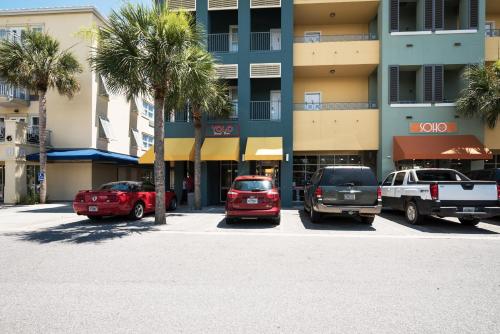 a parking lot with cars parked in front of a building at Lazy Daze at Gulf Place 208 in Santa Rosa Beach