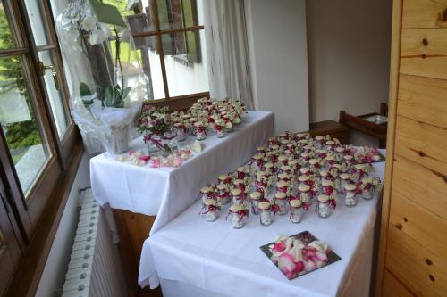 a group of tables with roses in vases on them at ALBERGO VALLUNGA in Tartano