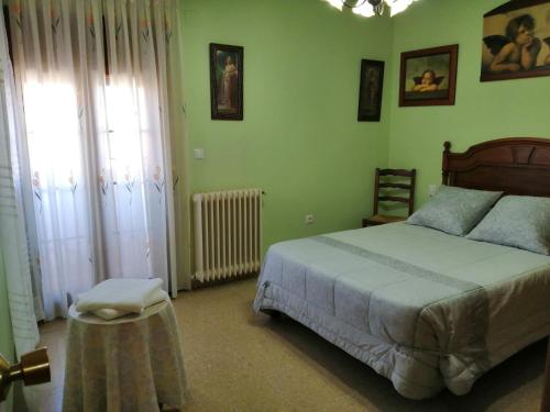 Un dormitorio con una cama y una mesa. en Casa rural Quebrada del Toro, en Ossa de Montiel