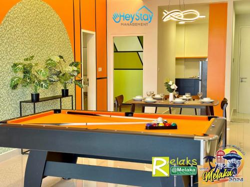 a lobby with a pool table in a room at The Apple Residence By Heystay Management in Melaka