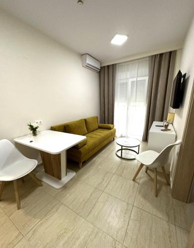 a living room with a couch and a table at Navarino Luxe Suites in Perea