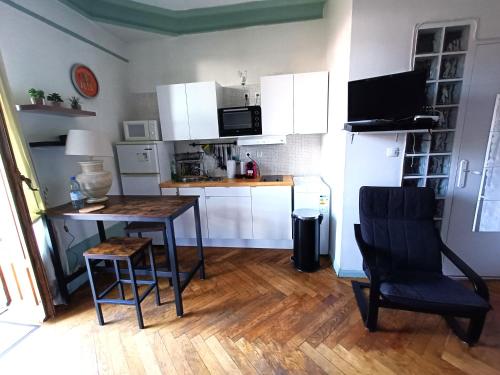 a small kitchen with a table and a chair at Chez Anna in Aix-les-Bains