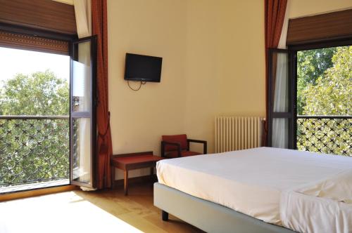 a bedroom with a bed and a large window at Hotel San Guido in Milan