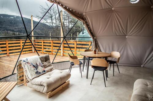 a room with a tent with a table and chairs at BUNNY GLAMP in Korbielów