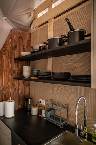 a kitchen counter with pots and pans and a sink at BUNNY GLAMP in Korbielów