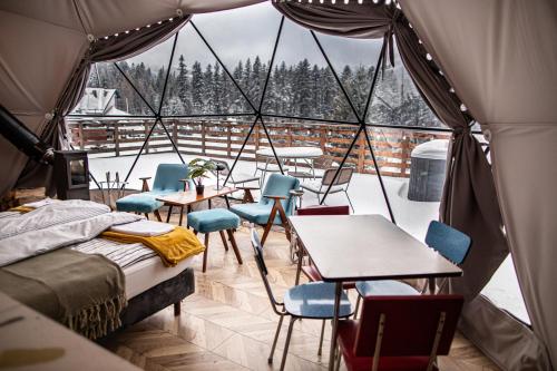 a room with tables and chairs in a tent at BUNNY GLAMP in Korbielów