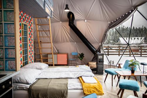 a bedroom with a bed in a tent at BUNNY GLAMP in Korbielów