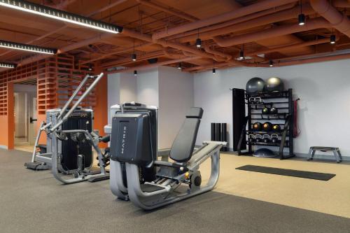 a gym with two exercise bikes and a tv at Aloft Kansas City Country Club Plaza in Kansas City