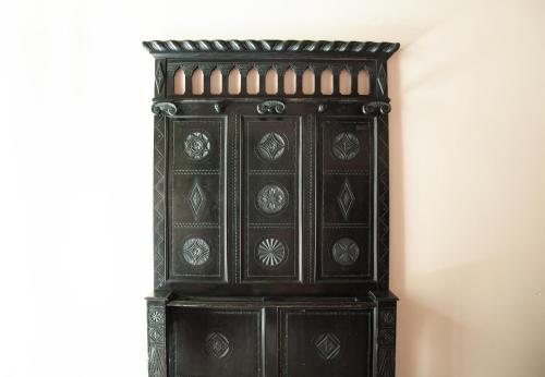 an antique wooden cabinet in a corner of a room at Hotel San Guido in Milan