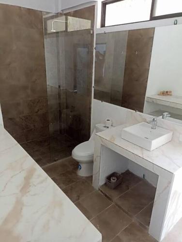 a bathroom with a toilet and a sink and a shower at Ayampe Kachalotes, Beach house, The best view in Ayampe