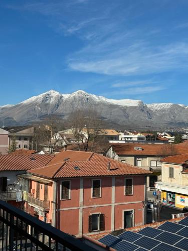 a view of a city with a snow covered mountain at La La Home in Avezzano