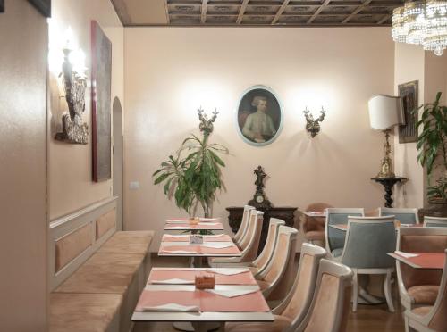 a dining room with a long table and chairs at Hotel San Guido in Milan