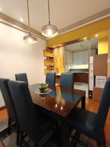 a dining room with a table and chairs at De Leon Staycation at Vista de Loro in Ternate
