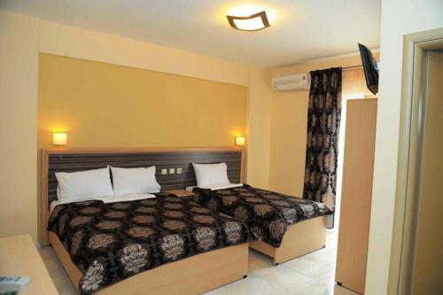 a bedroom with a bed with two pillows on it at Villa-Andromeda in Paralia Katerinis