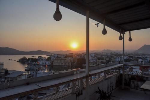 a view of the sunset from the balcony of a building at Sajjan Villa in Udaipur