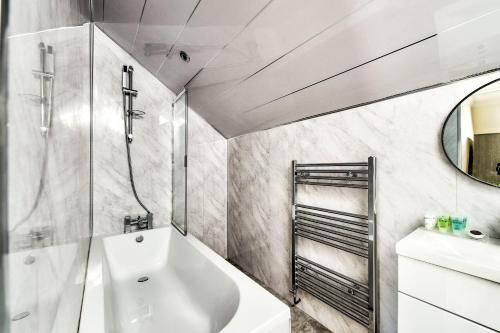 a bathroom with a white sink and a shower at Stunning 5 bedroom apt, close to city centre, SEC, Hydro and motorway in Glasgow