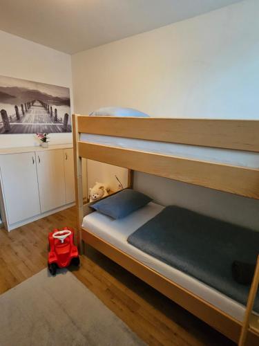a bedroom with two bunk beds and a red backpack at Apartment Zoya in Kranjska Gora