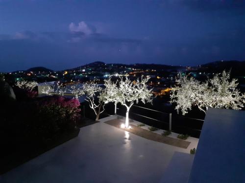 a night view of trees on a balcony with lights at Villa INARIME in Ischia