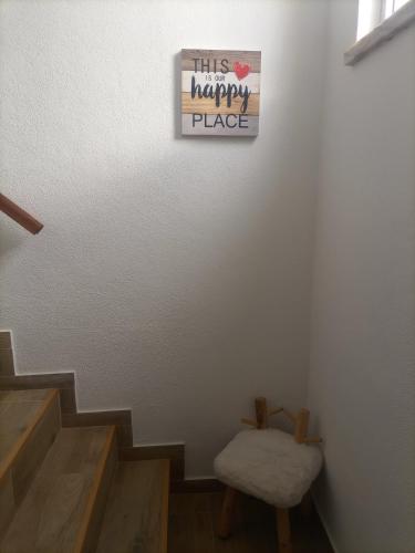 a stairway with a sign that reads this happy place at O Mundo da Lua in Azeitao