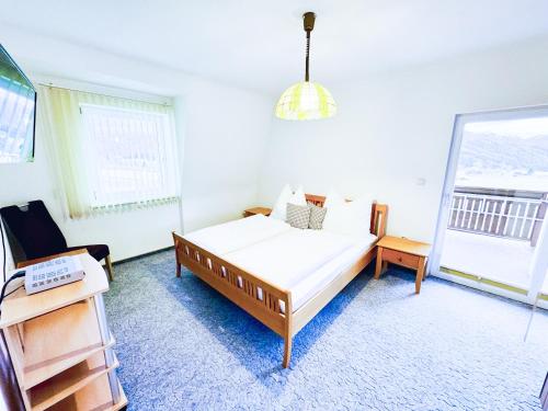 a bedroom with a bed and a desk and a window at Ferienhaus Am Hofacker in Aflenz Kurort