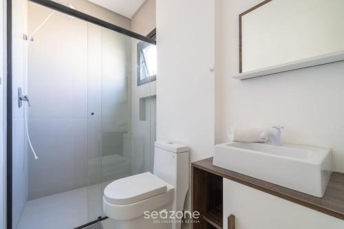 ein Bad mit einem WC, einem Waschbecken und einer Dusche in der Unterkunft Apto confortável a 5 min da praia ROT1001 in Itapema