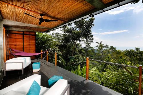 a balcony with a view of the forest at Kura Boutique Hotel Member of the Cayuga Collection in Uvita