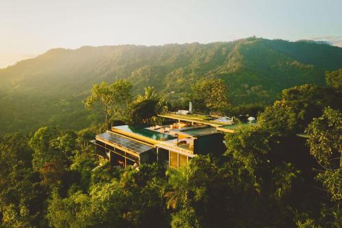 an aerial view of a house in the middle of a mountain at Kura Boutique Hotel Member of the Cayuga Collection in Uvita