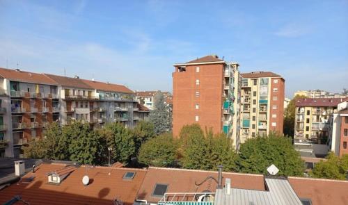 a view of a city with tall buildings and trees at Sweet Home in Torino Cenisia in Turin