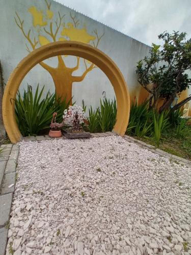 a painting of a tree on the side of a wall at O Mundo da Lua in Azeitao