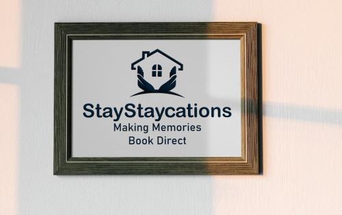 a picture of a sign in a frame on a wall at Green Glades Annex by StayStaycations in Bristol