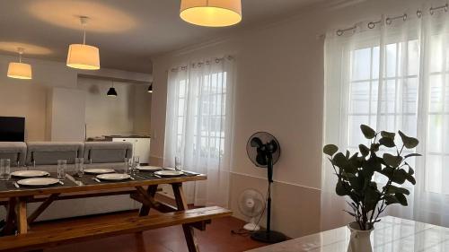a living room with a table and a couch at Espírito Azul Guest House - Rooms To Rent, 2 minutes walking from the beach, Marina and our Dive Center in Vila Franca do Campo