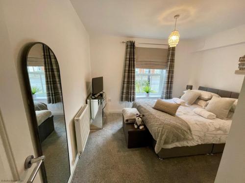 a bedroom with a bed and a large window at Bliss On The Bay in Filey