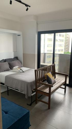een slaapkamer met een bed, een bank en een raam bij Loft Alto Padrão Moderno - VN Capote in Sao Paulo