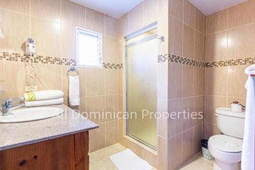 a bathroom with a toilet and a sink and a shower at Alicia Beach, Hispanola Sol, Sosua Center, guest friendly! in Sosúa
