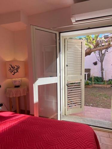 a bedroom with a bed and a sliding glass door at SOLEMARE in Palau