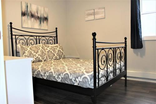 a bedroom with a bed with a black frame at Luxury Boutique 2 Bedroom Condo - 1B in Niagara Falls
