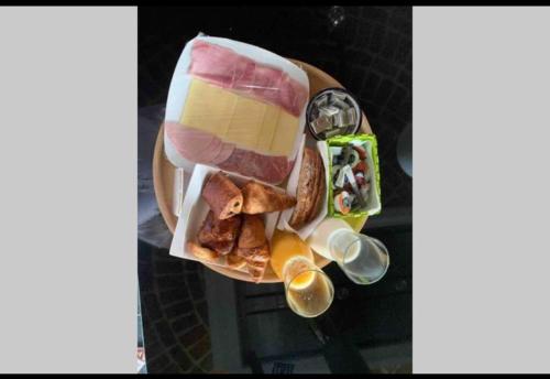 a plate of food with meat and cheese and other foods at Gîte du Fenil in Lobbes