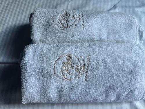 a stack of towels with a flower on them at Russ Spa in Mladenovac