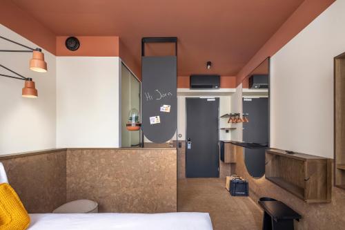 a hotel room with a bed and a desk at The Usual Rotterdam in Rotterdam