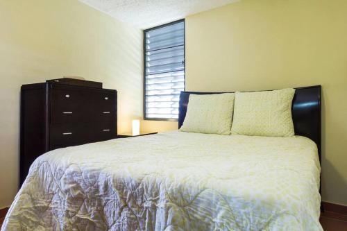 a bedroom with a bed with a dresser and a window at Beach House-Villa Taina, Boqueron Deposit Required in Cabo Rojo