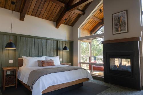a bedroom with a bed and a fireplace at Firefall Ranch Yosemite in Groveland