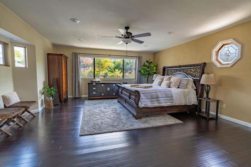 a bedroom with a bed and a ceiling fan at Resort style back yard heated pool and spa in Encinitas