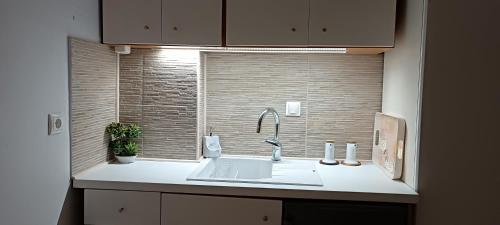 a kitchen counter with a sink and a window at Actis studios 1 in Stelida